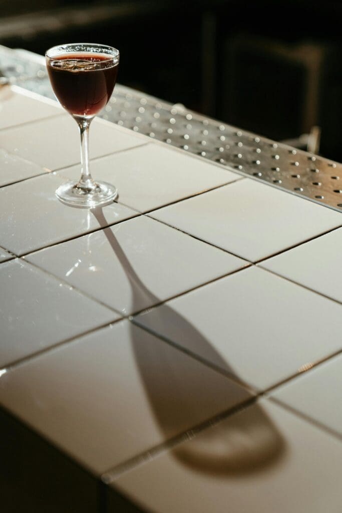 Wine of glass being served at a elegant restaurant bar top